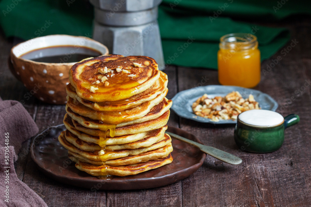 Apple pancakes served with honey, sour cream, nuts, tea and coffee.