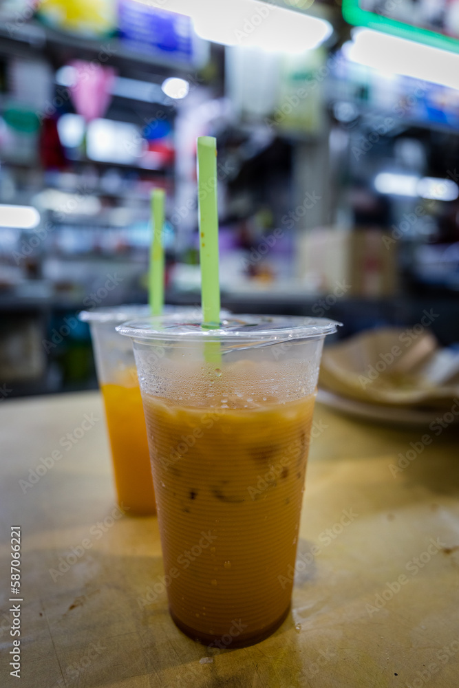 Teh tarick - coffee with ice and condensed milk in Singapore food court. Teh tarick - coffee with ice and condensed milk in Singapore food court.