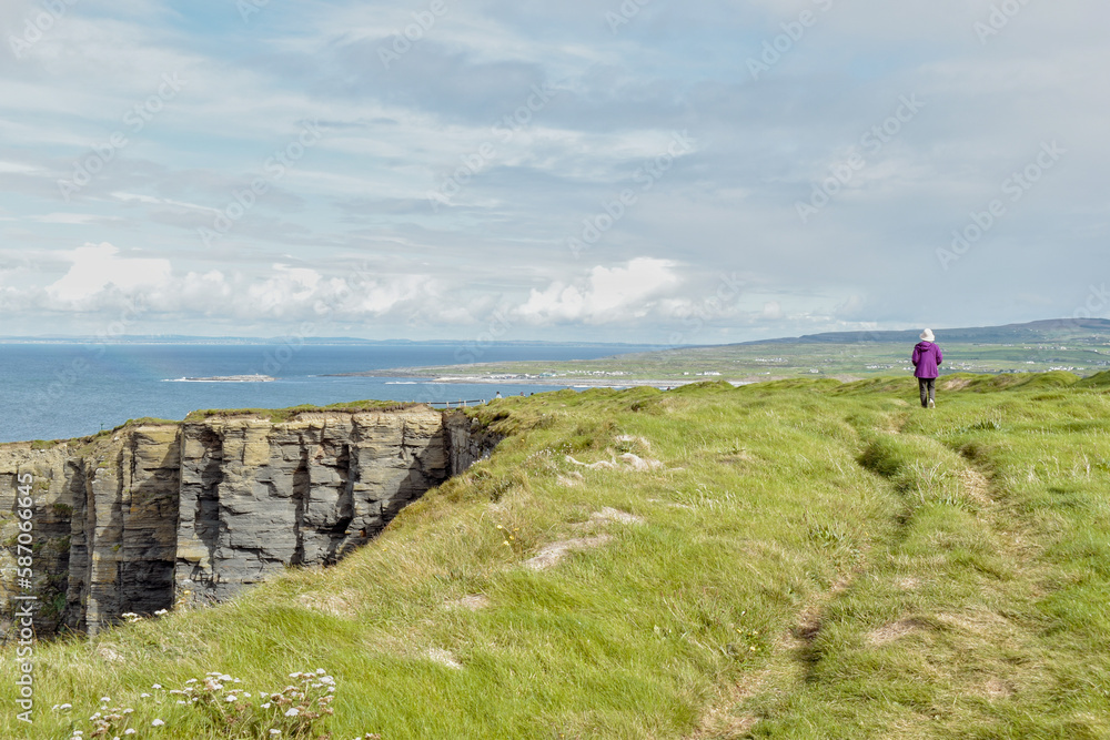Person on Cliffs of Mohar walking trail Person on Cliffs of Mohar walking trail