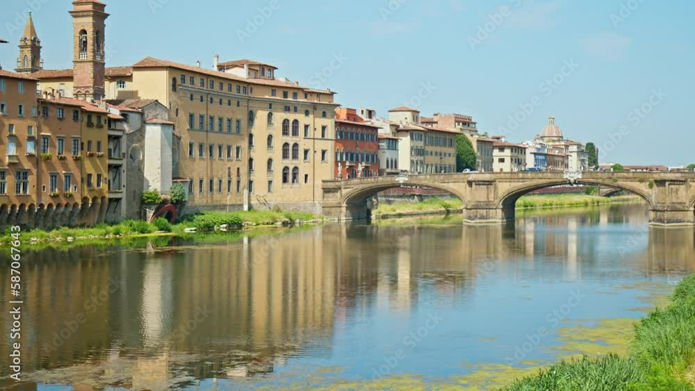 The famous and unique Ponte Vecchio bridge in Florence, Italy with shops along the walkway. Picturesque medieval archer river bridge of Roman origin surrounded by colorful houses and buildings. The famous and unique Ponte Vecchio bridge in Florence, Italy with shops along the walkway. Picturesque medieval archer river bridge of Roman origin surrounded by colorful houses and buildings.