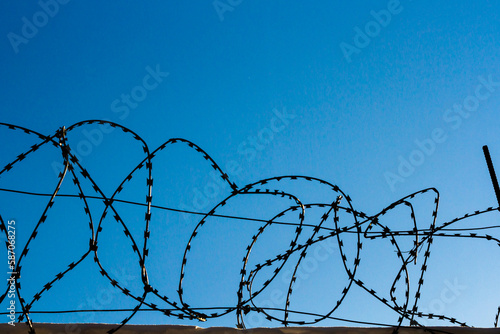 Barbed wire on the prison fence. A closed prison. Security concept. Forbidden territory.