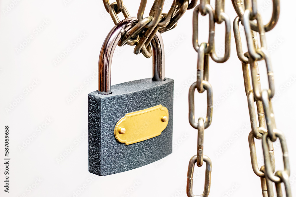 Padlock and chain. The lock connects two pieces of chain Padlock and chain. The lock connects two pieces of chain