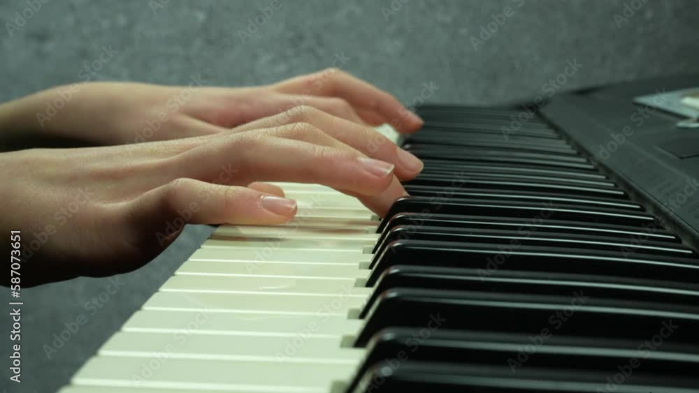 Closeup girl's hands slowly plays the synthesizer
Closeup girl's hands slowly plays the synthesizer