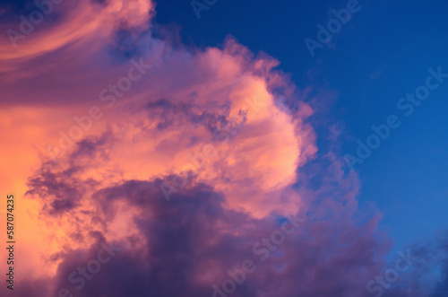 abstract background of a storm cloud colored by the sun