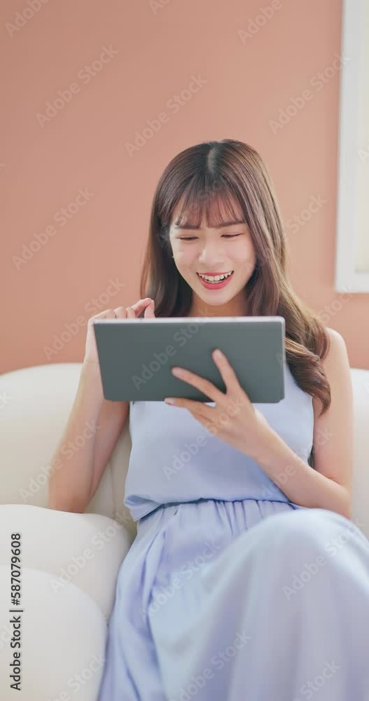 asian girl playing tablet happily asian girl playing tablet happily