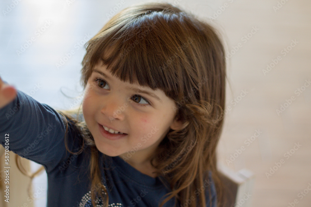 Close-up image of an adorable smiling little brunette girl.
Close-up image of an adorable smiling little brunette girl.