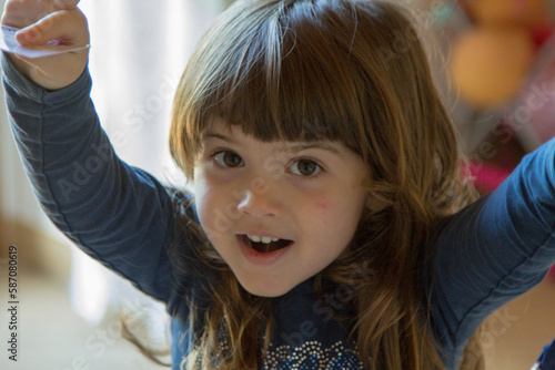 Close-up image of an adorable smiling little brunette girl. 