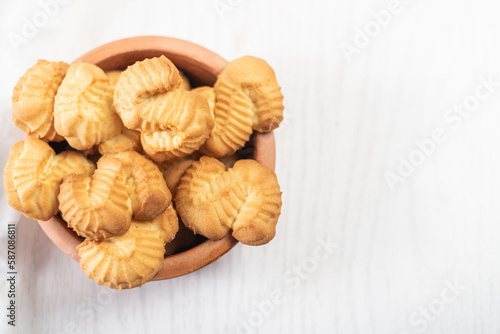 biscuits with orange and vanilla flavors in a plate on white wooden background 