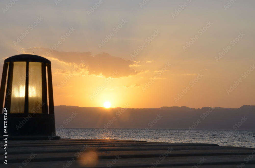 A lamp in front of the sunset on the Red Sea at Aqaba