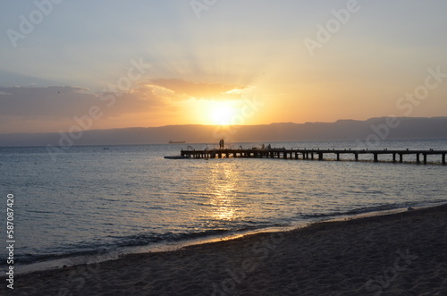 A couple against the sunset on a pier in Aqaba on the Red Sea