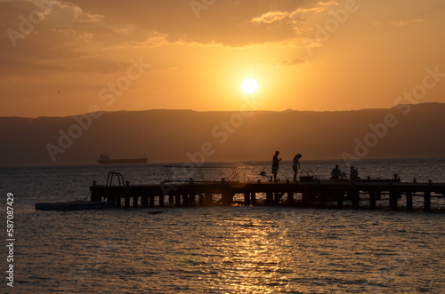 A couple against the sunset on a pier in Aqaba on the Red Sea