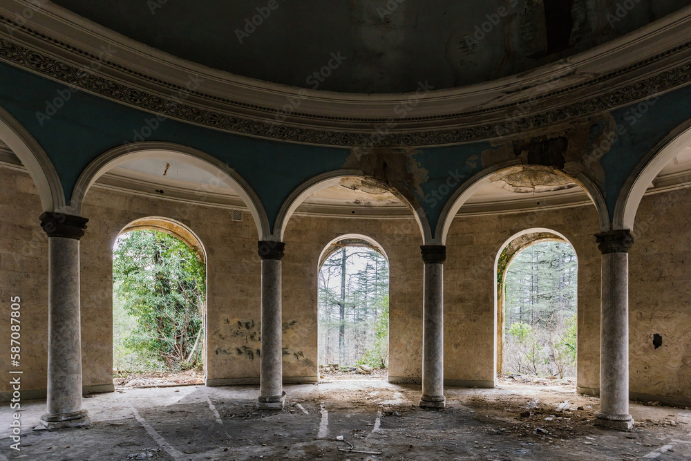 Round hall with colonnade in old abandoned palace