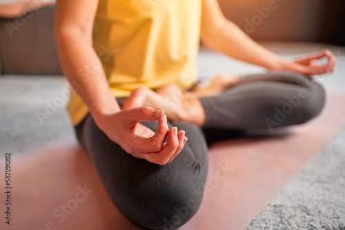 Cropped image of woman practicing yoga and meditation. Lotus pose.