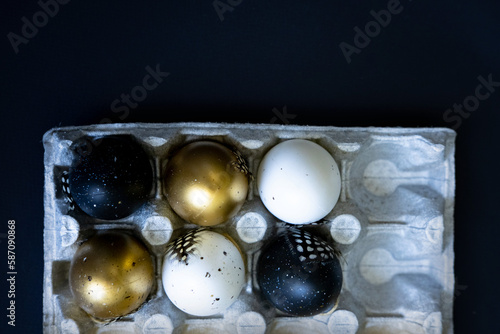 Easter eggs on dark background. Happy Easter concept. Golden hues for seasonal projects. Copy space. Close-up