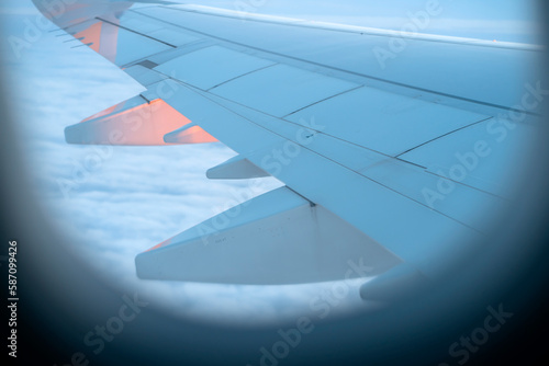 A wing of the airplane  view from a window.