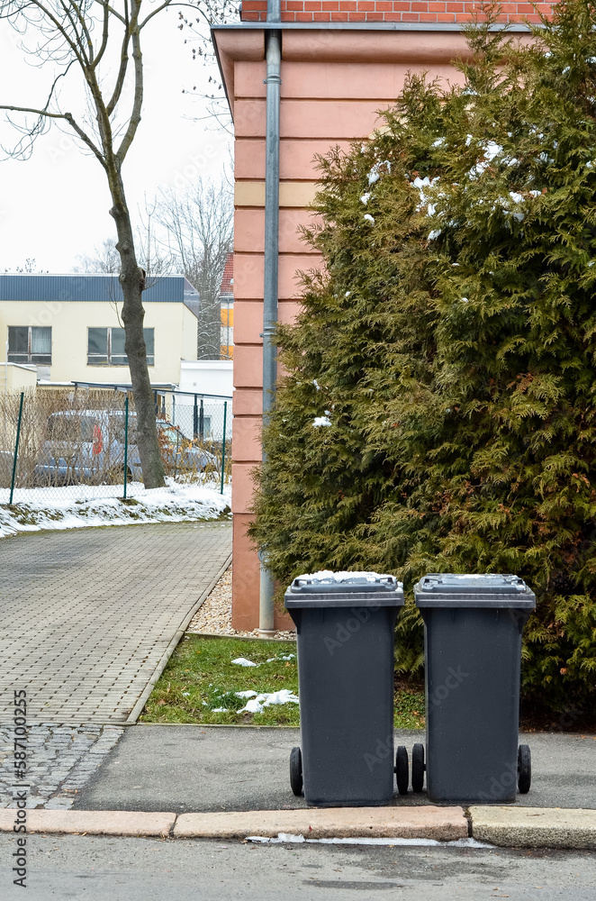 View of garbage containers in city on winter day View of garbage containers in city on winter day