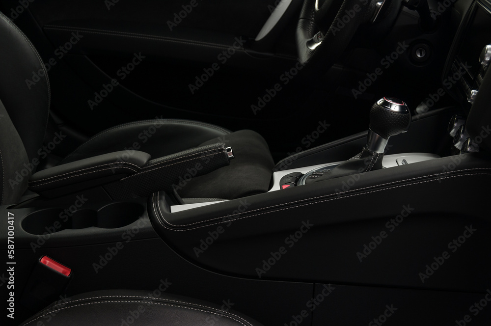 Car interior detail. Shift lever in modern sport car. Viev from passenger seat.