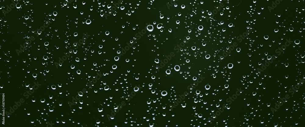 Obraz premium Atmospheric minimal monochrome backdrop with rain droplets on glass. Wet window with rainy drops and dirt spots closeup. Blurry minimalist background of dirty window glass with raindrops close up.