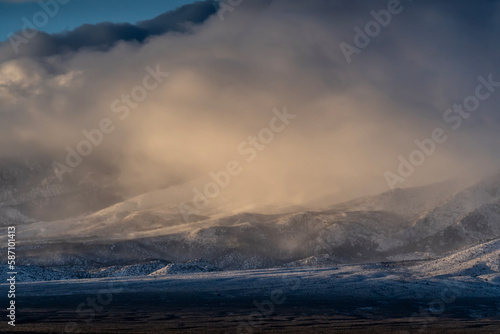 Mountain in Nevada after snow storm near highway. Cloud low and touch mountain.