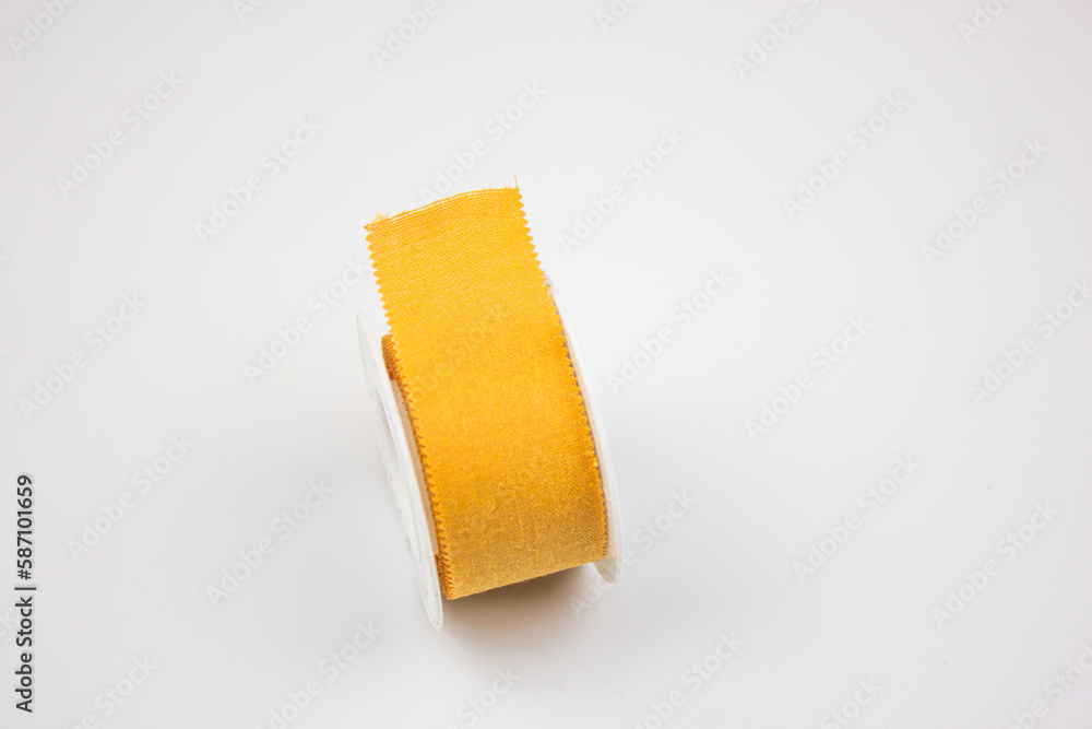 Obraz premium Plaster medical for wounds.Reel with a plaster on a white background. Yellow medical patch.