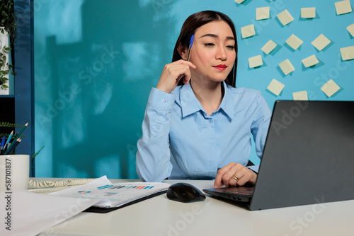 Thoughtful female worker plans to improve the work strategies of the company, using creative imagination for growth. Professional woman contemplating the best business idea.