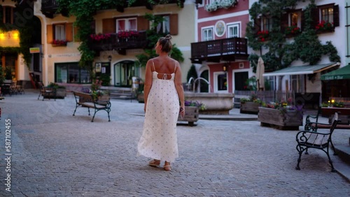 Woman is walking in Hallstatt street at evening time, 4k footage