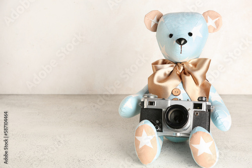 Toy bear with photo camera ...