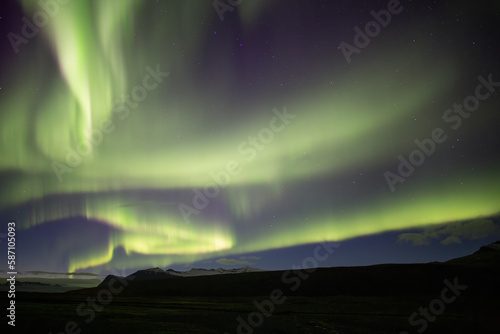 Full sky Aurora borealis over mountains, Skaftafell national park, Iceland