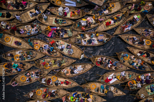 Top view of boats filled with travelers crossing the river to their workplace