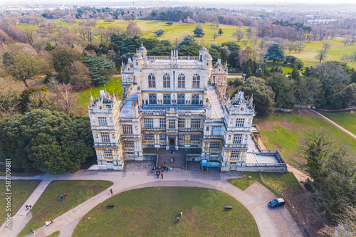 scenic drone shot of the front side of Wollaton Hall and visitors entering there, Nottingham, UK. High quality photo