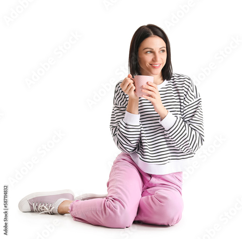 Pretty young woman with cup...
