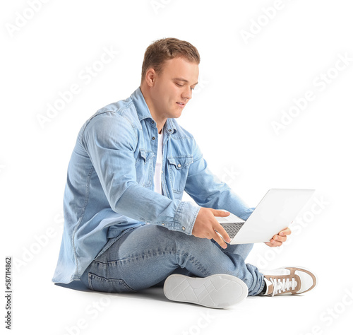 Young man using laptop on w...