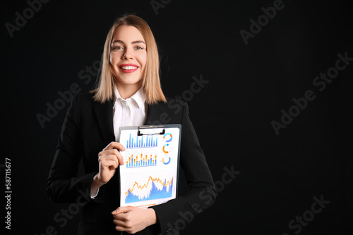 Female business consultant with clipboard on black background