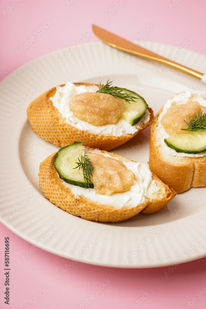 Delicious canapes with caviar of capelin on pink background Delicious canapes with caviar of capelin on pink background
