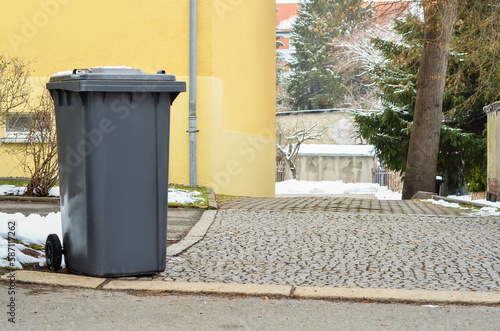 View of garbage container in city on winter day