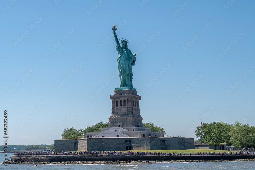 Statue of Liberty during sunny day in New York. Symbol freedom of the USA.