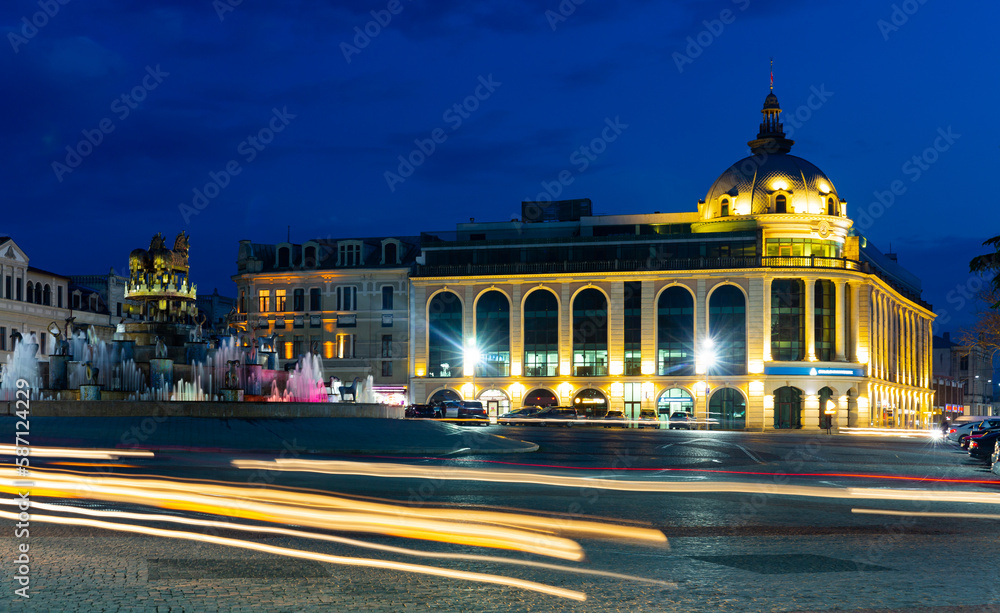 View of illuminated central square of Kutaisi with huge cascade structure of Colchis Fountain on spring night, Georgia