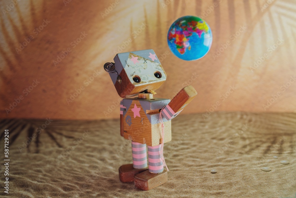 robot de madera jugando con pelota de globo terráqueo