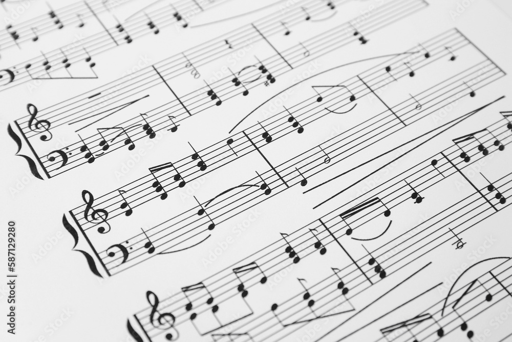 Sheet of paper with music notes as background, closeup view Sheet of paper with music notes as background, closeup view