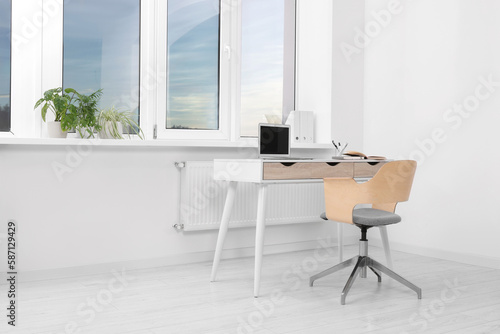 Comfortable workplace near window in stylish room. Home office © New Africa