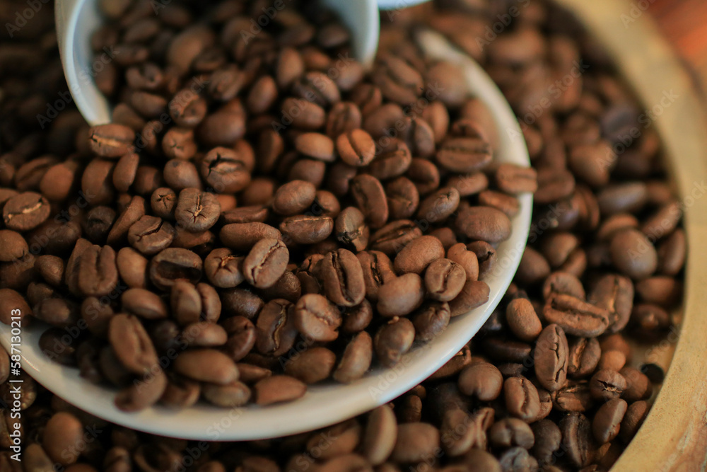 Roasted coffee beans in white cup. retro style toned, copy space. Background and texture of roasted coffee beans Roasted coffee beans in white cup. retro style toned, copy space. Background and texture of roasted coffee beans