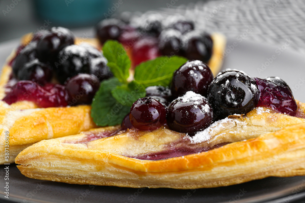 Fresh tasty puff pastry with sugar powder, jam, sweet berries and mint, closeup Fresh tasty puff pastry with sugar powder, jam, sweet berries and mint, closeup