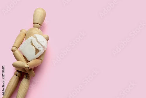 Wooden mannequin holding ca...