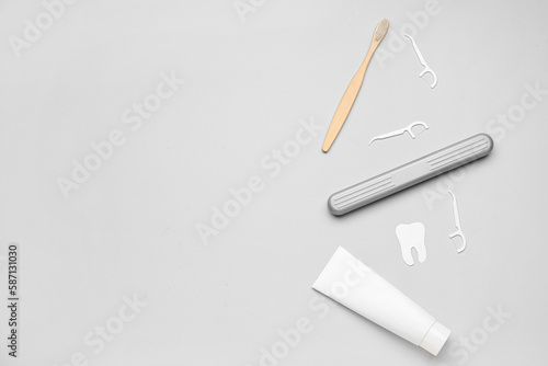 Wallpaper Mural Floss toothpicks, tube of paste, brush and tooth model on grey background Torontodigital.ca