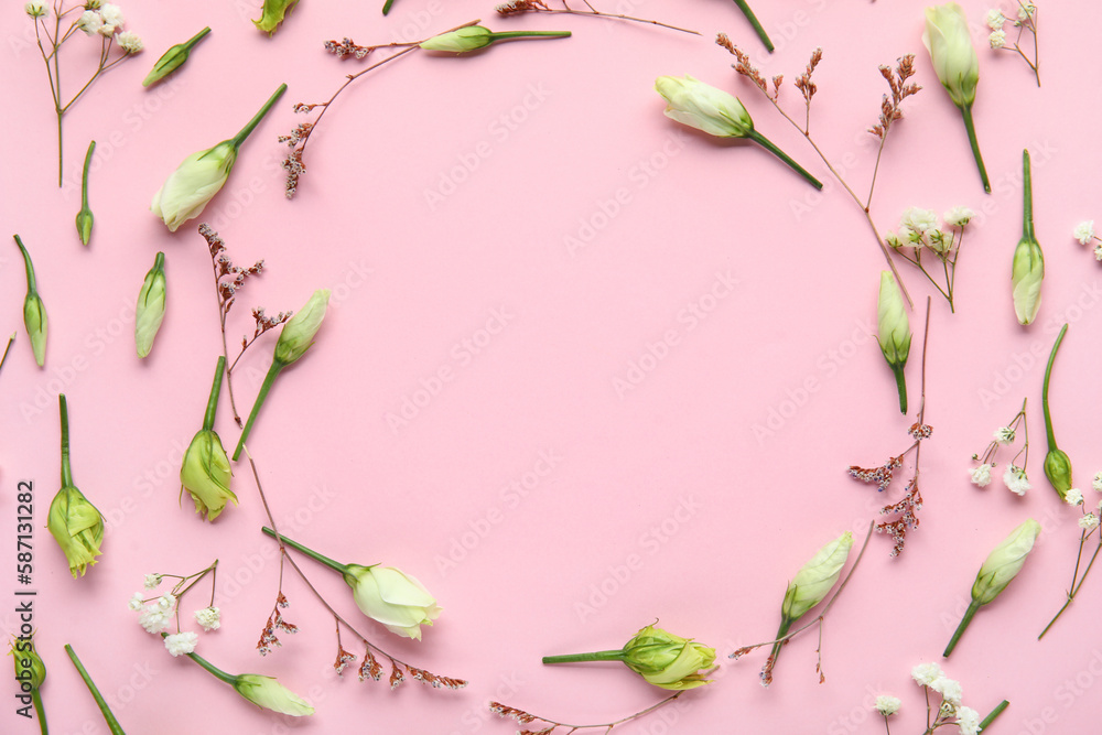 Frame made of beautiful flowers on pink background