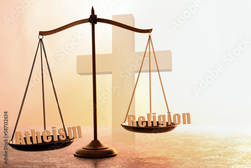 Choice between atheism and religion. Scales with words on textured surface against cross