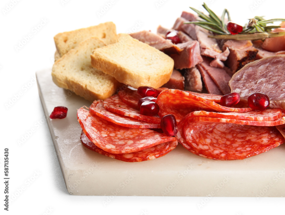 Board with assortment of tasty deli meats isolated on white background, closeup