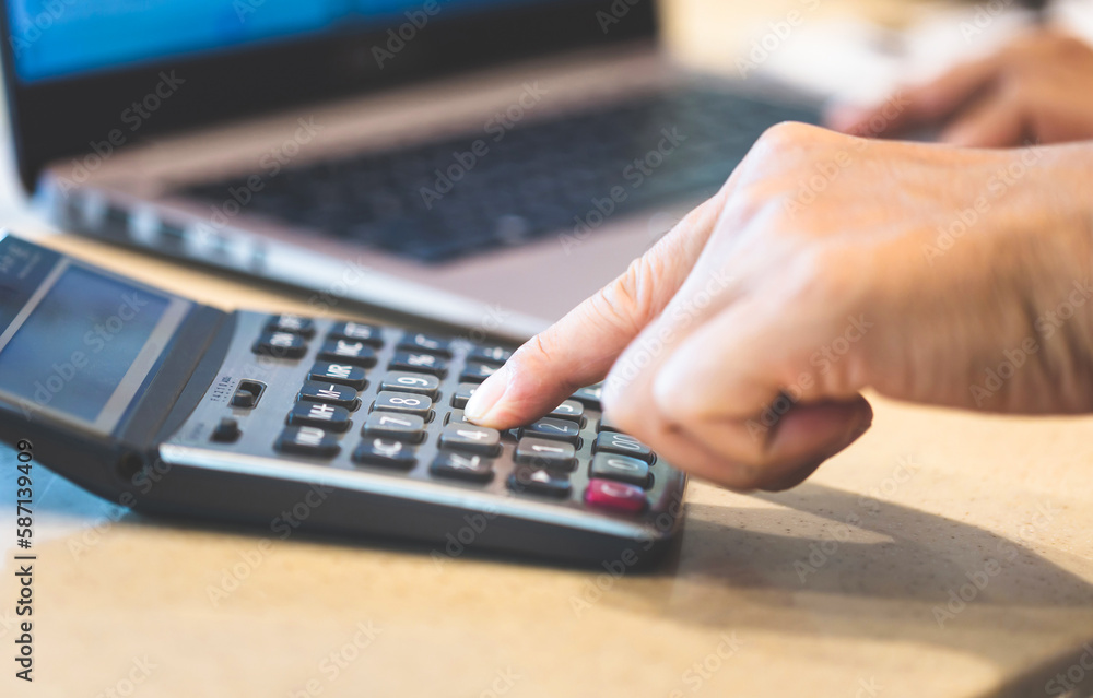 Close up of Man hand using calculator and laptop Close up of Man hand using calculator and laptop