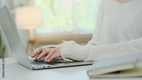 Young creative woman hands typing on laptop keyboard at working desk. Freelance work, technology and commutication concept. photo