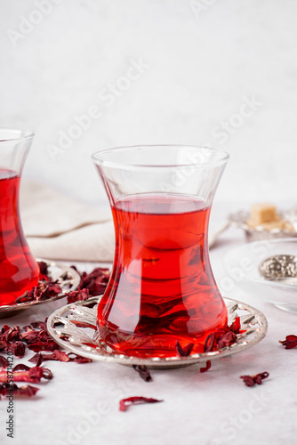 Glass of Turkish hibiscus tea on white table
